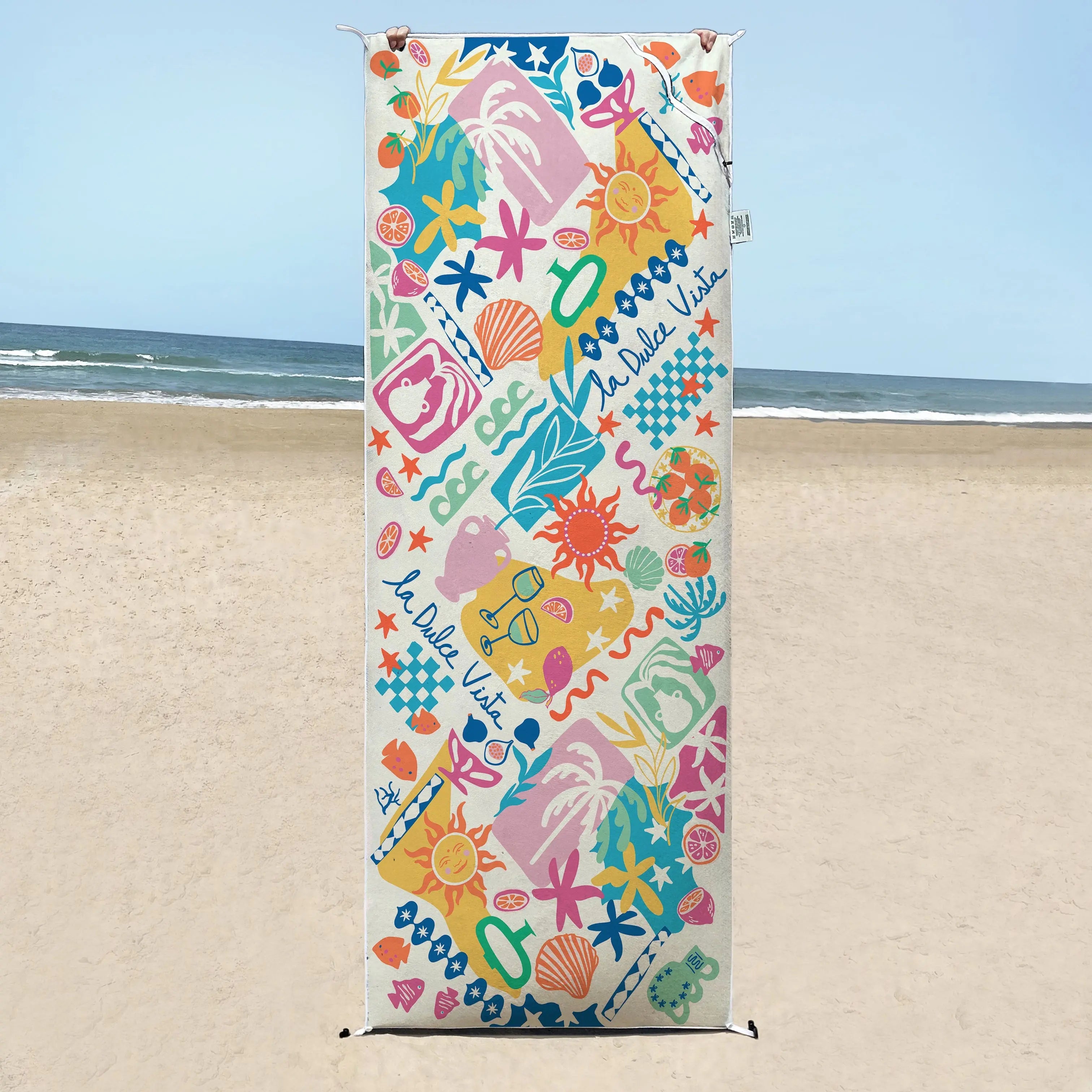 Amalfi coast sand free travel beach towel with pocket on clear beach with ocean in back in australia