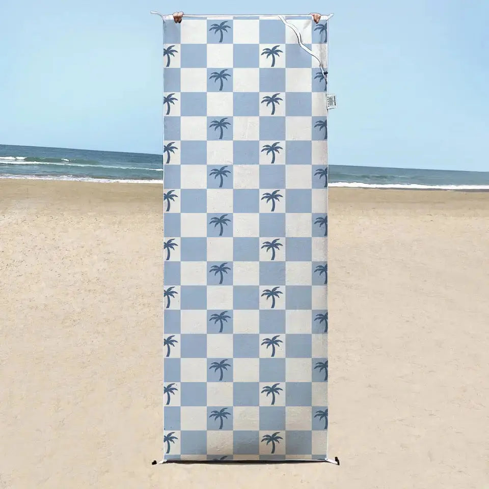 Malibu Blue Checkered sand free Beach Towel With Pocket on white sand beach in Australia