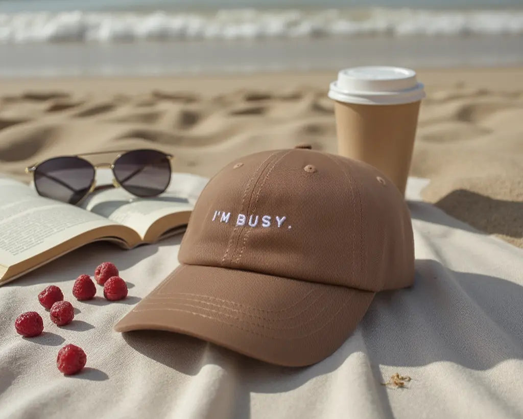 brown I'm busy hat funny trending slogan womens australia beach baseball cap on. a beach in gold coast australia with a coffee