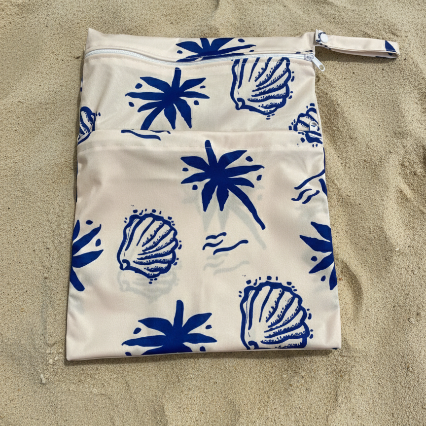 A towel bag with repeating designs of beautiful blue Santorini shells and palm tress