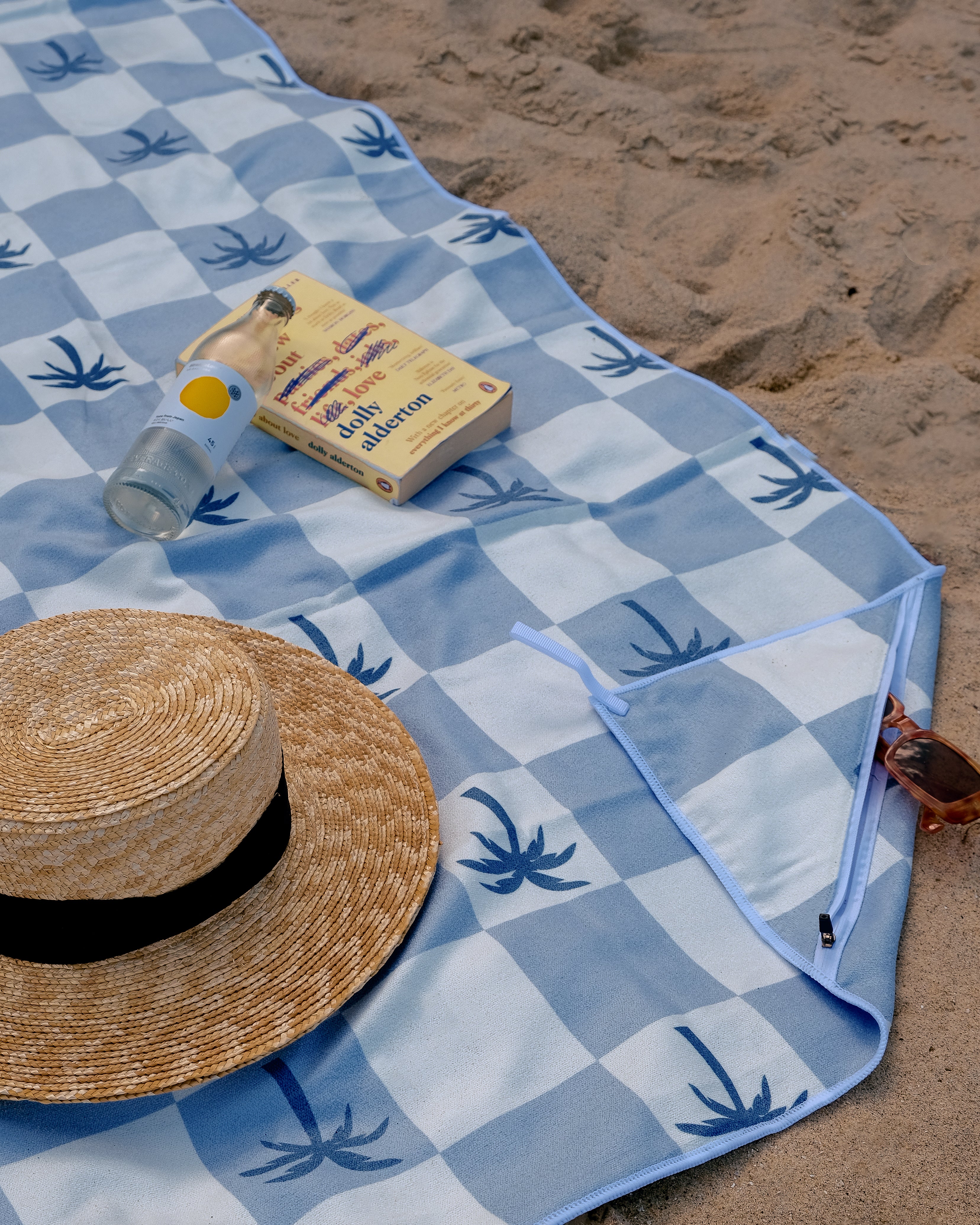 Malibu_Blue_Checkered_sand_free_Beach_Towel_With_Pocket_on_white_sand_beach_in_Australia_2