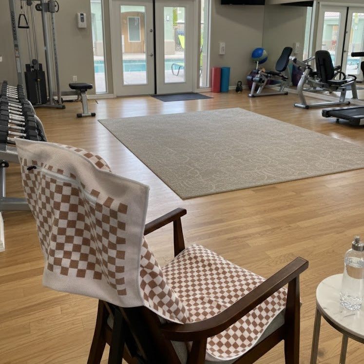 A timeless brown-and-white checkerboard pattern, creating a clean, modern look that stands out while remaining neutral and easy to style in any gym setting.